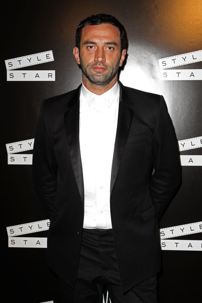 surrounding Riccardo Tisci