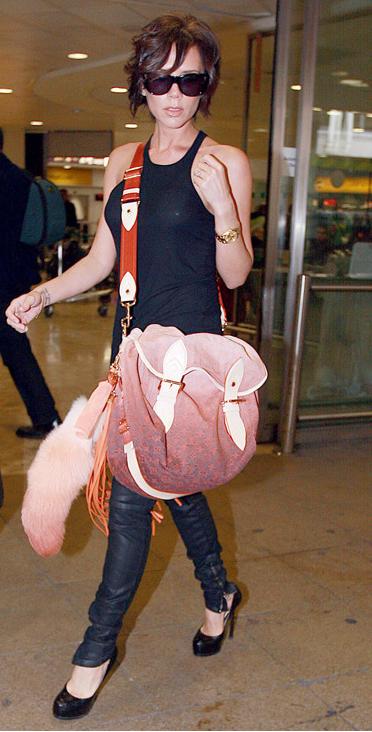 Victoria Beckham wearing a Louis Vuitton SS10 bag