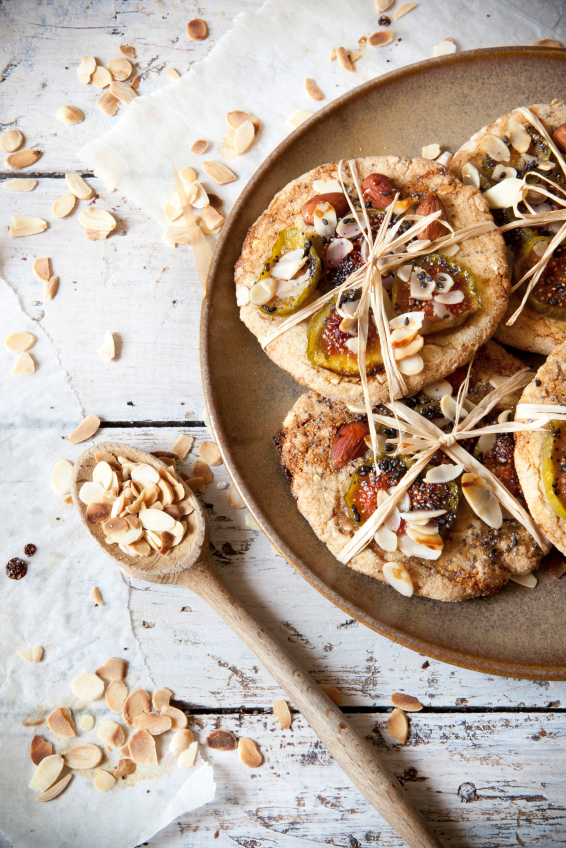 homemade rustic gift cookies with bio figs and almond slices with seed on plate wooden table
